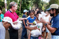 During his 2009 visit to Nicaragua Andrew helped Ambassador's staff member, Pastor Daniel Ortega Reyes (far right) distribute food.