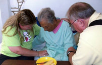 Ambassadors ministers more than humanitarian aid. Here Karen prays for an elderly woman.